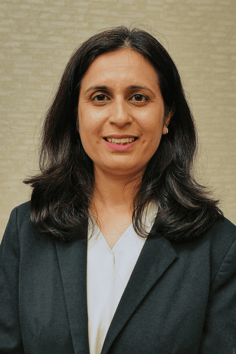Professional woman smiling in business attire.