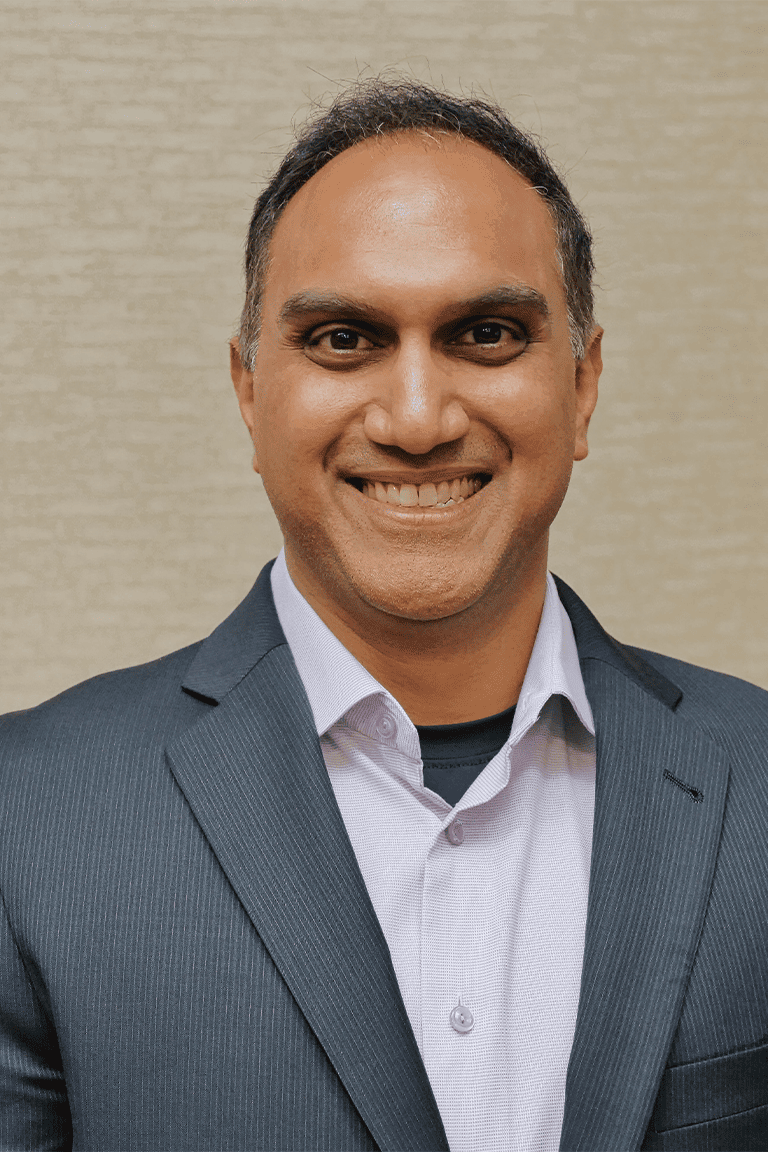 Smiling businessman in a suit and tie.