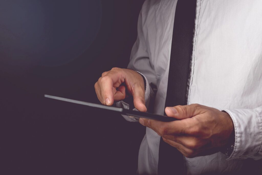 Man using tablet in dark background